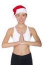 Smiling asian woman in Santa`s hat engaged in fitness