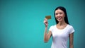 Smiling asian woman showing golden card into camera, limitless credit, banking