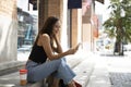 Asian woman sitting on stairs using smart phone. Royalty Free Stock Photo