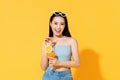 Smiling Asian woman in summer outfit with a glass of orange juice Royalty Free Stock Photo