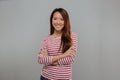 Smiling asian woman in sweater posing with crossed arms Royalty Free Stock Photo