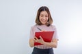 Smiling asian woman taking notes with pen on clipboard, looking happy Royalty Free Stock Photo