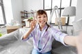 smiling asian woman taking selfie at new home Royalty Free Stock Photo