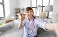 smiling asian woman taking selfie at new home Royalty Free Stock Photo