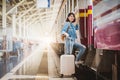 Woman tourist with luggage getting on the train Royalty Free Stock Photo