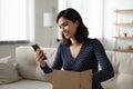 Smiling asian woman unpack postal package with order Royalty Free Stock Photo