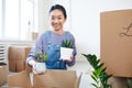 Smiling Asian Woman Unpacking Boxes in New Home Royalty Free Stock Photo