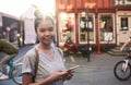 Smiling Asian woman walking in the city using her cellphone Royalty Free Stock Photo