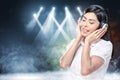 Smiling asian woman in white shirt listening music with headphones Royalty Free Stock Photo