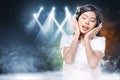 Smiling asian woman in white shirt listening music with headphones Royalty Free Stock Photo