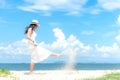 Smiling asian woman white wearing fashion summer walking on the sandy ocean beach. Woman enjoy and relax vacation. Royalty Free Stock Photo