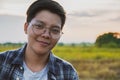 Smiling Asian women are short hair in eyeglasses standing on the field, only one portrait Lesbian