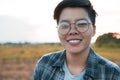 Smiling Asian women are short hair in eyeglasses standing on the field, only one portrait Lesbian
