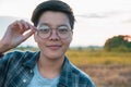 Smiling Asian women are short hair in eyeglasses standing on the field, only one portrait Lesbian