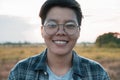 Smiling Asian women are short hair in eyeglasses standing on the field, only one portrait Lesbian. Soft focus