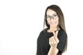 Smiling asian young business woman with mini heart sign. Royalty Free Stock Photo