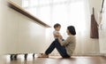 Smiling Asian Young mother playing with her little cute son in kitchen at home. Mother`s day Royalty Free Stock Photo