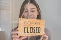 Smiling asian young owner retail, coffee shop woman turning sign board to closed after finished work, job and protection to