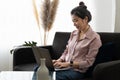 Smiling asian young woman working on laptop at home office. Young asian student using computer remote studying, virtual Royalty Free Stock Photo