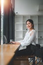 Smiling asian young woman working on laptop at home office. Young asian student using computer remote studying Royalty Free Stock Photo