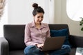 Smiling asian young woman working on laptop at home office. Young asian student using computer remote studying, virtual Royalty Free Stock Photo