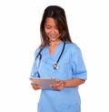 Smiling asiatic nurse woman working on tablet pc Royalty Free Stock Photo