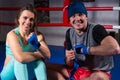 Smiling athletic boxing couple preparing bandages Royalty Free Stock Photo