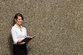 Smiling attractive business woman writing in notebook