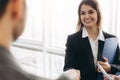 Smiling attractive businesswoman handshaking with businessman after pleasant talk, good relationships. Business concept photo