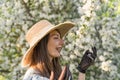 Smiling attractive caucasian woman in retro clothes with straw hat and vintage black lace gloves. Cottagecore. Royalty Free Stock Photo