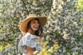 Smiling attractive caucasian woman in retro clothes with straw hat and vintage black lace gloves. Cottagecore. Royalty Free Stock Photo