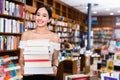 Smiling attractive girl holding pile of books bought in bookstor Royalty Free Stock Photo