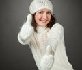 Smiling attractive girl showing thumbs up in mittens Royalty Free Stock Photo