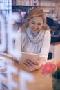 Smiling attractive mature woman using tablet sitting from behind Royalty Free Stock Photo