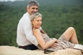 smiling attractive middle-aged couple relaxing at beach