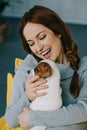 smiling attractive pregnant woman hugging jack russell terrier