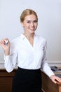 smiling attractive receptionist holding key Royalty Free Stock Photo