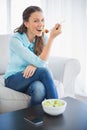 Smiling attractive woman eating healthy salad Royalty Free Stock Photo