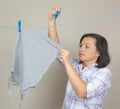 Smiling Attractive Woman Hanging Wet Clean Cloth To Dry On Cloth Royalty Free Stock Photo