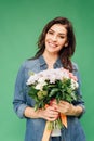 Smiling attractive woman holding flower bouquet and looking at camera isolated Royalty Free Stock Photo