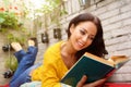 Smiling attractive woman reading book Royalty Free Stock Photo