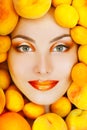 Smiling attractive woman with ripe big fresh peaches and apricot