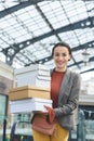 smiling attractive woman with shopping boxes looking