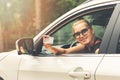 Smiling attractive woman showing her driver license Royalty Free Stock Photo