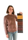 Smiling attractive woman in sweater holding fabric swatches Royalty Free Stock Photo