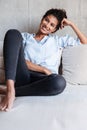 Smiling attractive young african woman wearing shirt relaxing Royalty Free Stock Photo