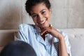 Smiling attractive young african woman wearing shirt relaxing Royalty Free Stock Photo