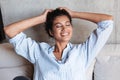 Smiling attractive young african woman wearing shirt relaxing Royalty Free Stock Photo