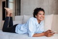 Smiling attractive young african woman wearing shirt relaxing Royalty Free Stock Photo