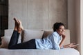 Smiling attractive young african woman wearing shirt relaxing Royalty Free Stock Photo